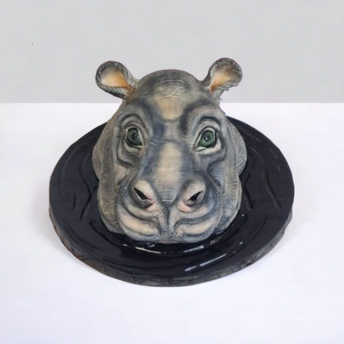 hippo cake"Realistic hippo cake with lifelike details, including textured skin, green eyes, and a water-themed base. Perfect for bespoke animal-themed cakes, 3D cake designs, and creative custom desserts."






